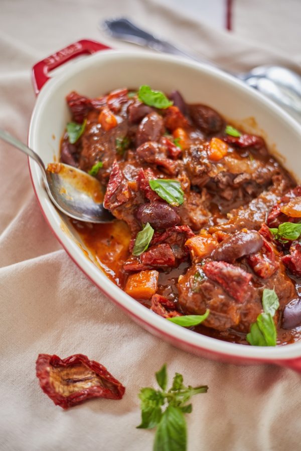 Slow cooked beef cheeks with black olives,  sun-dried tomatoes & basil · Serves 2